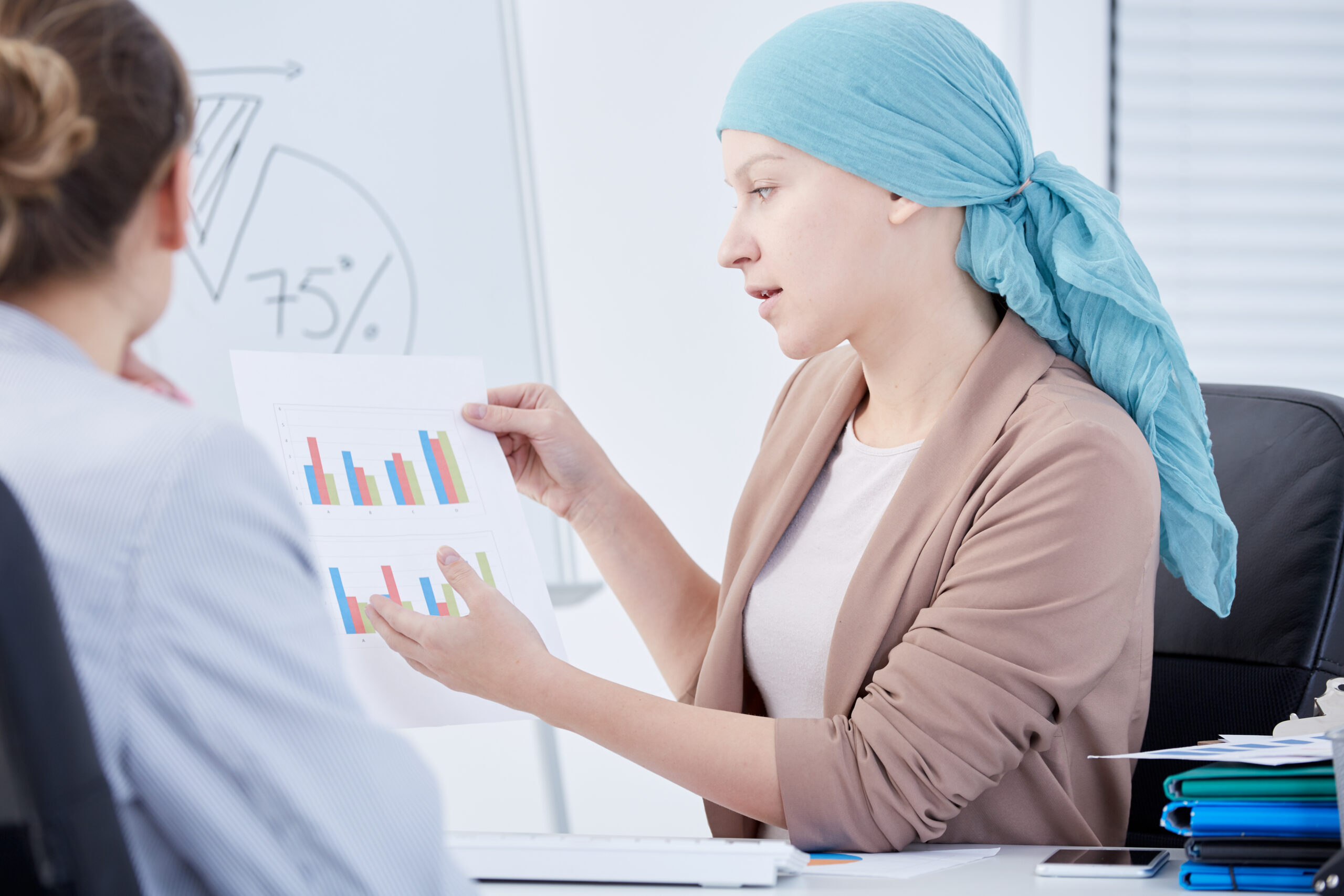 Patient and doctor discussing charts Cancer patient discussing charts with her doctor